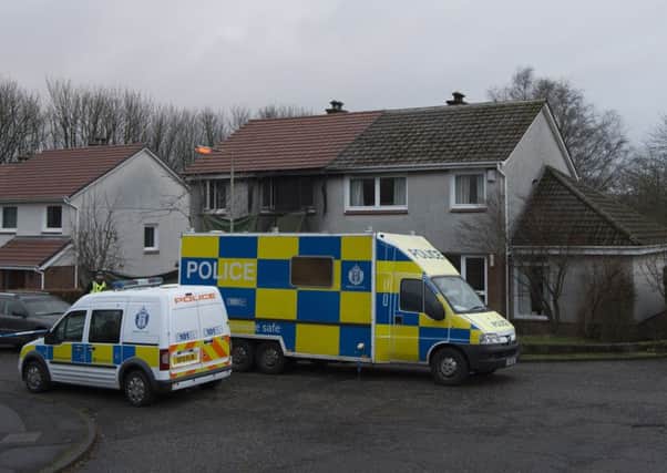 Police at the scene of a fire in Milngavie, East Dunbartonshire, after a 23-year-old man was murdered and his 24-year-old girlfriend seriously injured in the deliberate house fire on New Year's Day. Picture: John Linton/PA Wire