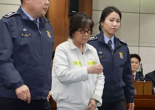 Choi Soon-Sil, the jailed confidante of disgraced South Korean President Park Geun-Hye, appears on the first day of her trial. Picture: AFP/Getty Images