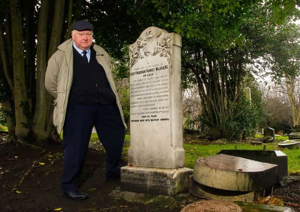 Edward Flint stands by the restored grave of Lieutenant Frederick Ramsay Walker. Picture: Scott Louden