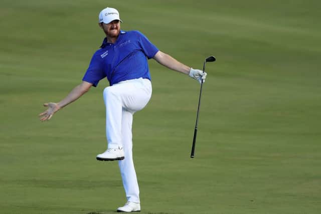 Jimmy Walker attempts to coax his ball into the 18th hole at Kapalua. Picture: Getty.