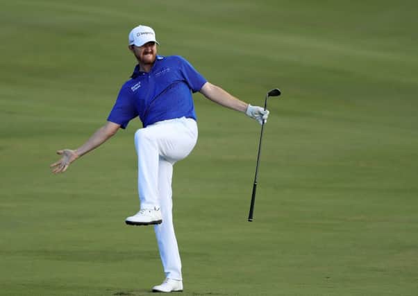 Jimmy Walker  attempts to coax his ball into the 18th hole at Kapalua. Picture: Getty.