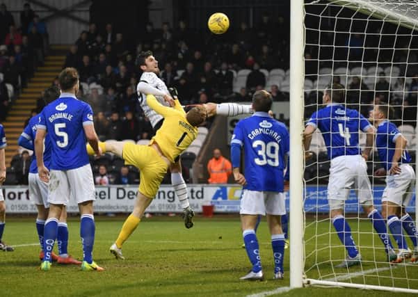 St Mirren's John Sutton comes close with a header for the home side during Saturday's 3-0 defeat by Queen of the South. Picture: SNS