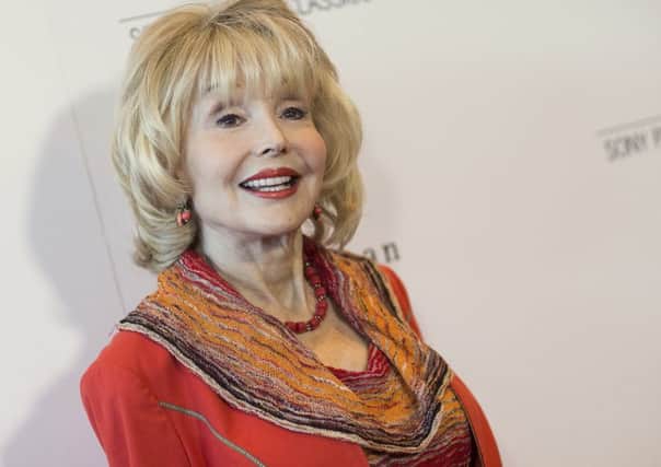 FILE - In this Thursday, July 9, 2015, file photo, actress Francine York arrives at the Los Angeles Premiere of "Irrational Man" held at the WGA Theatre in Beverly Hills, Calif. Francine York, a statuesque actress who appeared in dozens of TV shows and movies in a decades-long career, has died. She was 80. York died Friday, Jan. 6, 2017, at a Los Angeles hospital following a battle with cancer, said her friend, Pepper Jay. The 5-foot-8 York was born in Aurora, Minnesota and had a childhood dream of performing. She modeled and was a nightclub showgirl before starting an acting career in low-budget movies and bit parts on television shows such as "Rescue 8" and "Route 66." (Photo by John Salangsang/Invision/AP, File)
