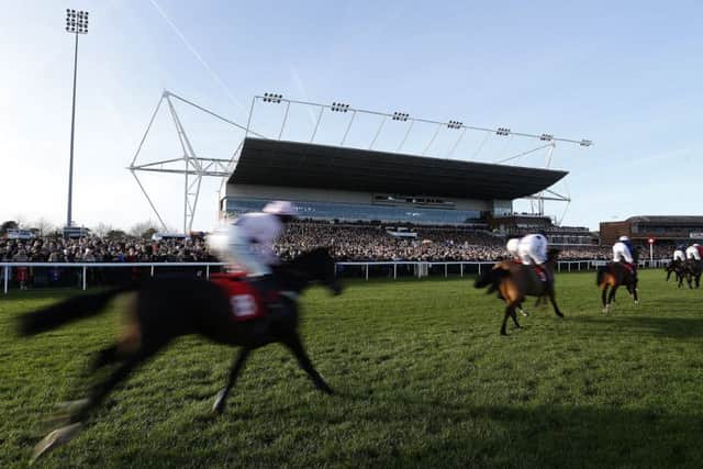 Runners pass the packed grandstand at Kempton Park on Boxing Day. Picture: Alan Crowhurst/Getty Images