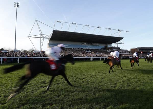 Runners pass the packed grandstand at Kempton Park on Boxing Day. Picture: Alan Crowhurst/Getty Images
