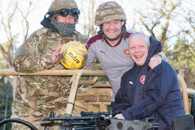Staff sergeant Richy Anderson, left, joins Hearts' John Robertson and Jimmy Sandison, right, to
promote the Army legends v Hearts legends clash, in aid of ABF, the soldiers' charity, on 5 March. Picture: Iain Georgeson