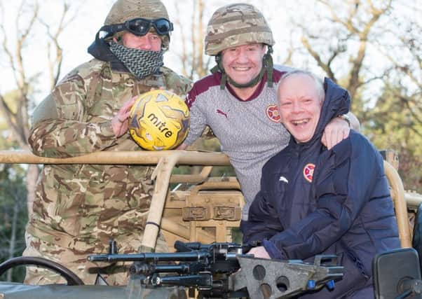 Staff sergeant Richy Anderson, left, joins Hearts' John Robertson and Jimmy Sandison, right, to
promote the Army legends v Hearts legends clash, in aid of ABF, the soldiers' charity, on 5 March. Picture: Iain Georgeson