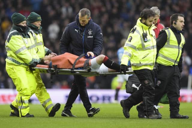 Rangers' Joe Garner had to be carried off after injuring his shoulder against Celtic. Picture: Alan Harvey/SNS