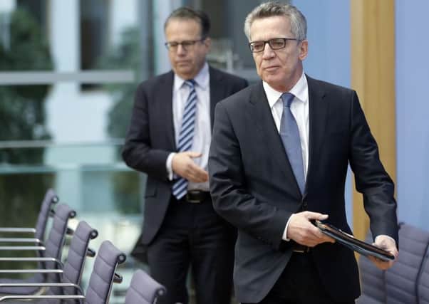 German Interior Minister Thomas de Maiziere, right, and Frank-Juergen Weise, head of the Federal Office for Migration and Refugees. Picture: AP