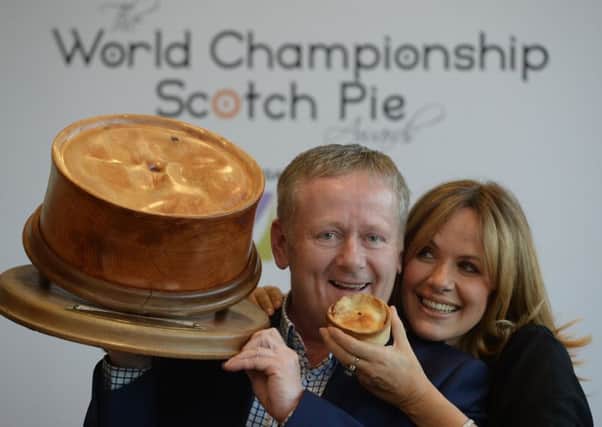 John Gall, of Brownings the Bakers, celebrates his firm's world Scotch Pie title with TV presenter Carol Smillie.