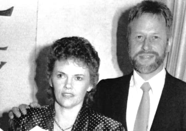 FILE - This October 1990, file photo shows Michael Chamberlain, right, and then his wife Lindy when Lindy launched her book on the disappearance of her baby daughter Azaria in 1980. Chamberlain, who waged a long battle to prove his baby daughter was killed by a dingo in Australia's most notorious case of injustice, has died, Chamberlain's ex-wife Lindy confirmed Tuesday,  Jan. 10, 2017. He was 72. (AP Photo/Russell McPhadran, File)