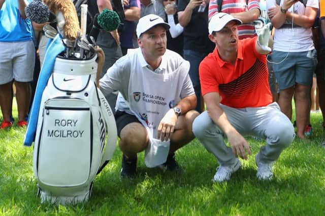 Rory McIlroy and his caddie line up his second shot on the eighth hole in the first round of the BMW South African Championship at Glendower Golf Club. Picture: Warren Little/Getty Images