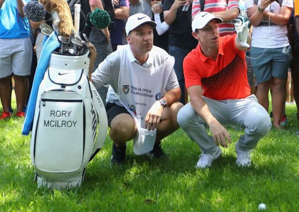 Rory McIlroy and his caddie line up his second shot on the eighth hole in the first round of the BMW South African Championship at Glendower Golf Club. Picture: Warren Little/Getty Images