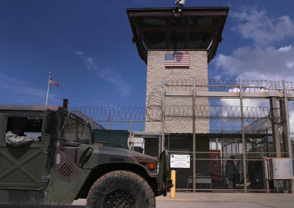 A humvee passes the guard tower guard tower at the entrance of the U.S. prison at Guantanamo Bay. Picture: Getty Images