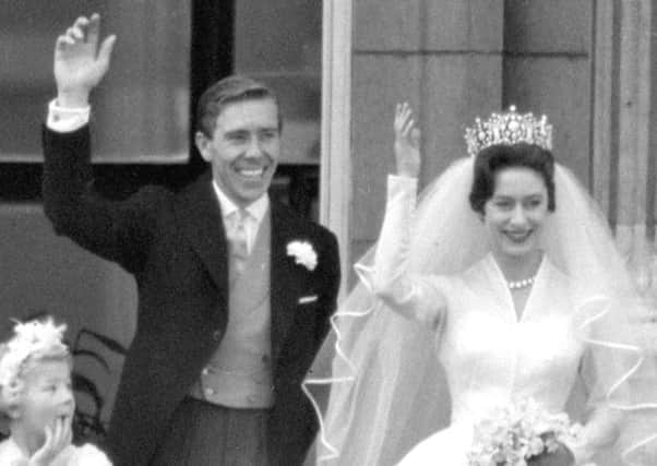 Princess Margaret and Lord Snowdon waving to the crowds on the balcony of Buckingham Palace after their wedding ceremony at Westminster Abbey. Picture: PA