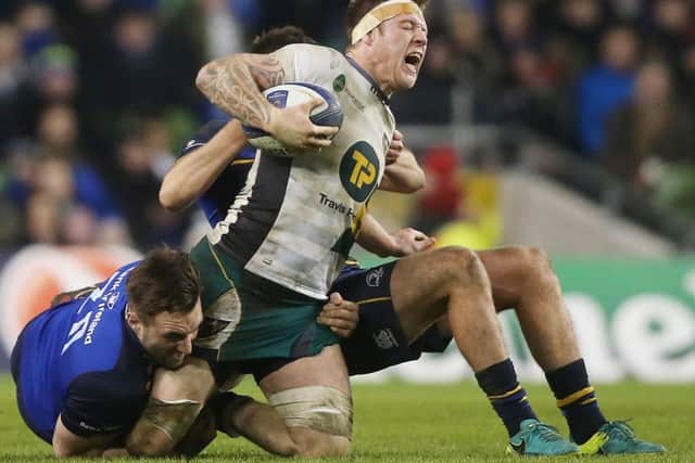 Northampton Saints' Teimana Harrison is tackled by Leinster's Jack Conan and Ross Byrne. Picture: PA.