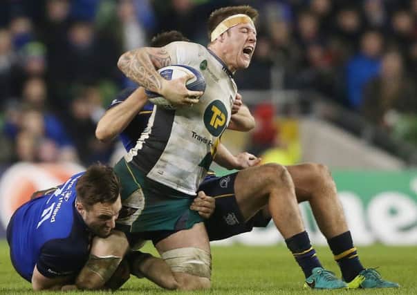 Northampton Saints' Teimana Harrison is tackled by Leinster's Jack Conan and Ross Byrne. Picture: PA.