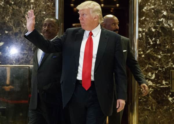 Donald Trump waves as he leaves the lobby of Trump Tower in New York. The US president-elect wants more support from Moscow in the fight against terrorism. Photograph: AP/Evan Vucci