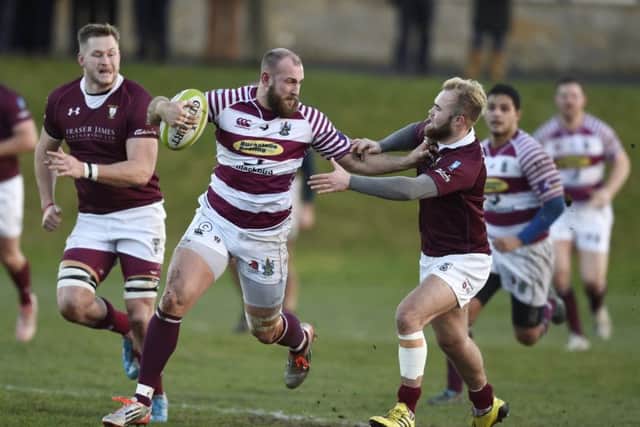 Watsonians Rory Drummond hands off Gala scrum-half Connor Adams at Myreside.  Picture: Ian Rutherford