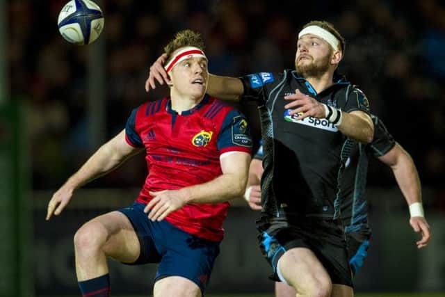 Finn Russell keeps his eye on the ball in a tussle with Munsters Rory Scannell. Picture: SNS.