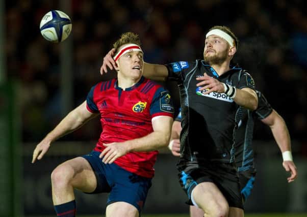 Finn Russell keeps his eye on the ball in a tussle with Munsters Rory Scannell. Picture: SNS.