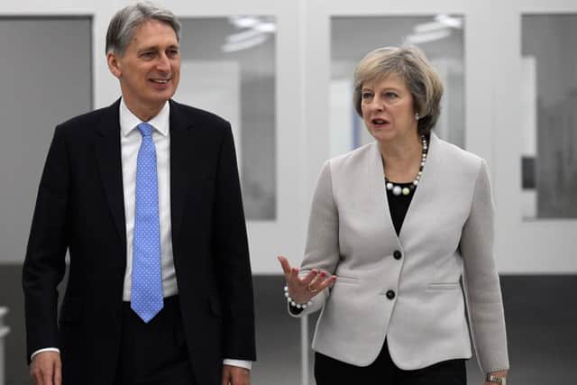 British Chancellor of the Exchequer Philip Hammond and British Prime Minister Theresa May tour engineering and scientific technology company Renishaw's innovation. Picture; getty