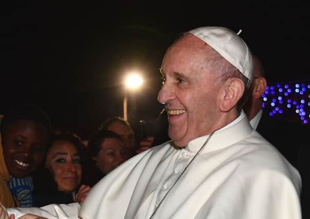 Pope Francis shakes hands with people after celebrating mass at the Santa Maria. Picture; Getty