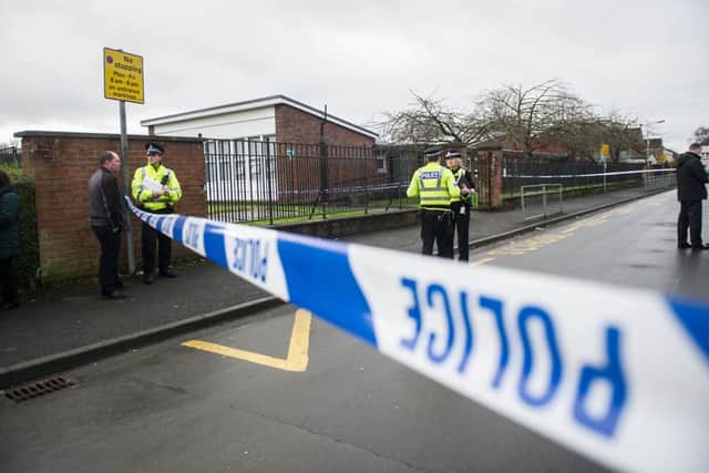 Police officers outside St George's primary school in Penilee, Glasgow, following reports of a shooting in a nearby street. Picture: John Devlin/TSPL