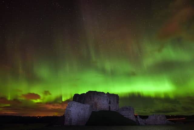 A powerful display of the Northern Lights, Aurora Borealis, lights up the night sky over the ruins of Duffus Castle near Duffus, Moray. Picture: SWNS