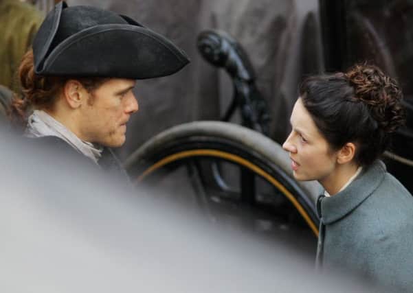 Sam Heughan and Caitriona Balfe pictured filming in Tweeddale Court. Picture: SWNS