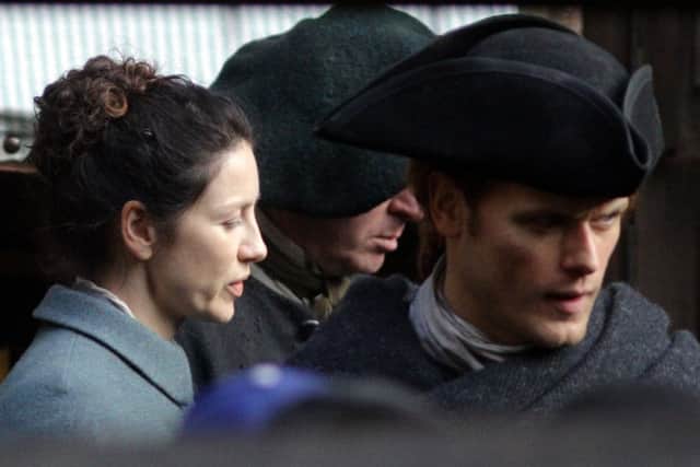 Caitriona Balfe, left, and Sam Heughan were filming in Edinburgh today. Picture: SWNS