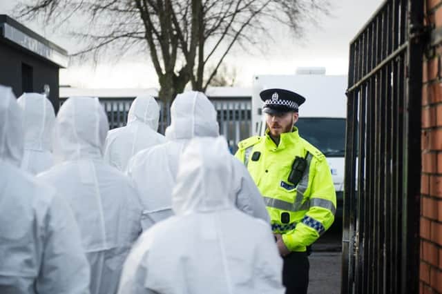 Forensic invesitgators enter the primary school yesterday. Picture: John Devlin/TSPL