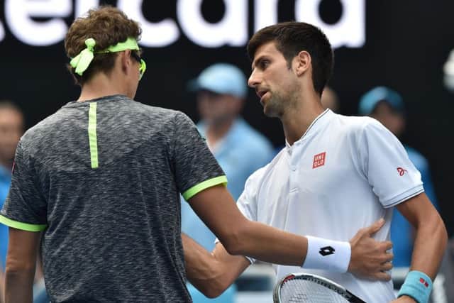 Serbia's Novak Djokovic, right, shakes hands with Uzbekistan's Denis Istomin after his shock defeat in the Australian Open second round. Picture: Paul Crock/AFP/Getty Images