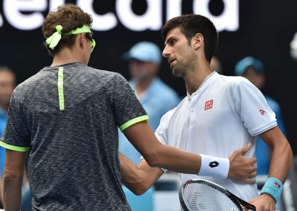 Serbia's Novak Djokovic, right, shakes hands with Uzbekistan's Denis Istomin after his shock defeat in the Australian Open second round. Picture: Paul Crock/AFP/Getty Images