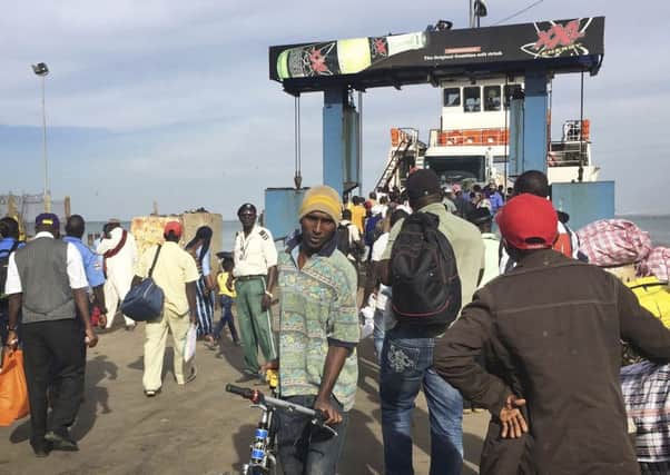 People board the ferry leaving Banjul, Gambia, as special flights were being organised to evacuate British and other tourists. AP photo