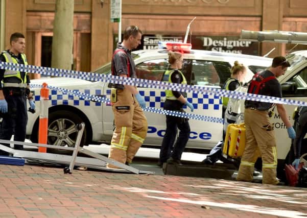 Emergency services tend to the injured after a driver ploughed into pedestrians in Melbourne, killing four. Picture: Getty