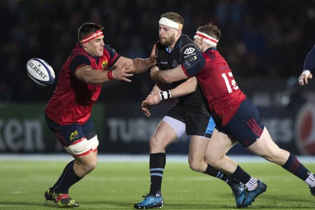 Finn Russell of Glasgow is tackled by Munster's Rory Scannell at Scotstoun. Picture: SNS/SRU