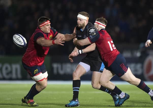 Finn Russell of Glasgow is tackled by Munster's Rory Scannell at Scotstoun. Picture: SNS/SRU