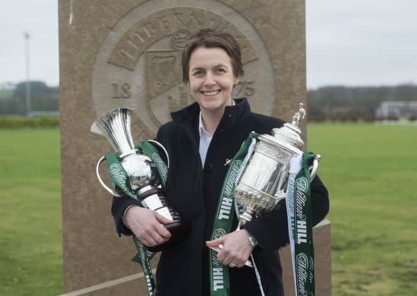 Hibs chief executive Leeann Dempster clutches the Scottish Cup and a commemorative cup presented to the club by sponsors William Hill. Picture: Craig Foy/SNS