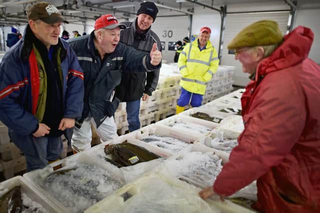 Buyers at Peterhead fish market. (Photo by Jeff J Mitchell/Getty Images)