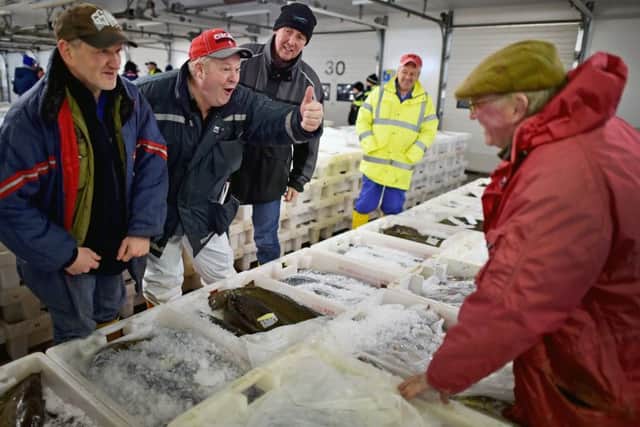 Buyers at Peterhead fish market.  (Photo by Jeff J Mitchell/Getty Images)