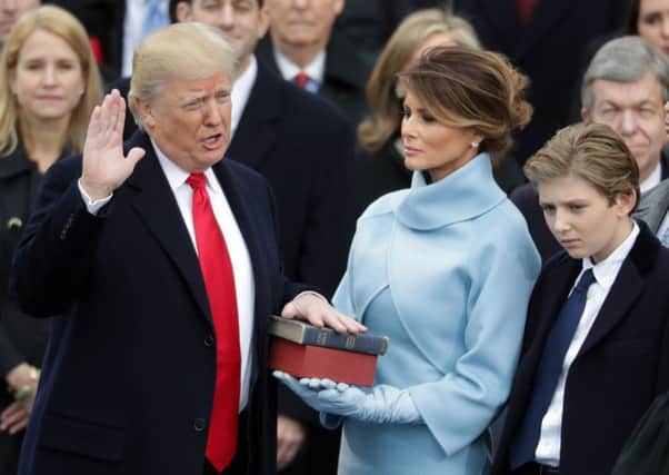 U.S. President Donald Trump takes the oath of office as his wife Melania Trump holds the bible and his son Barron Trump looks on. Picture: Getty