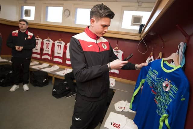Bonnyrigg Rose goalkeeper Dylan Rooney takes a snapshot of his kit ahead of the game. Picutre: SNS