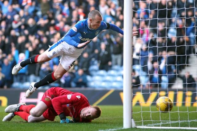 Kenny Miller soared through the air to plant a header past Craig Samson and spark a Rangers comeback. Photograph: Jane Barlow/PA