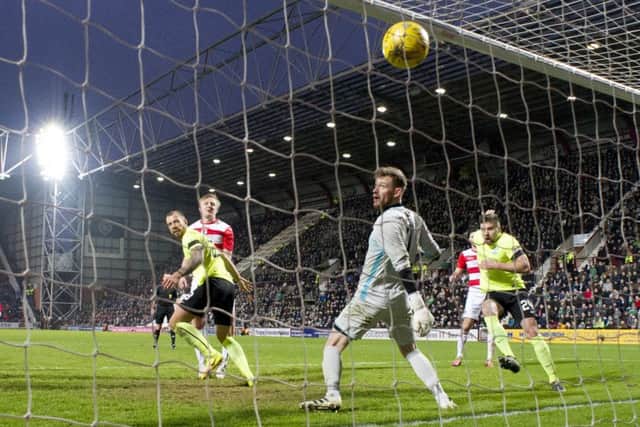 Hibs' Jordon Forster, left, scores his side's eighth goal. Picture: Alan Harvey/SNS