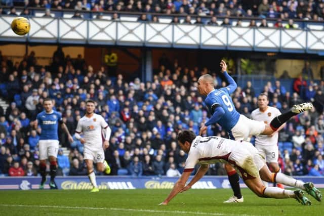 Rangers striker Kenny Miller heads home the first of his two goals against Motherwell. Picture: SNS