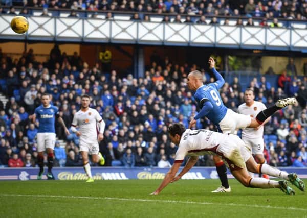 Rangers striker Kenny Miller heads home the first of his two goals against Motherwell. Picture: SNS