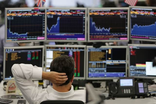 City trades keep an eye on the London market. Picture: Daniel Leal-Olivas/AFP/Getty Images