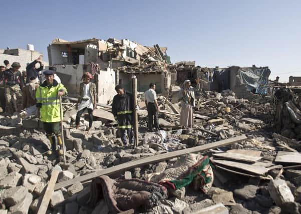 People search for survivors under the rubble of houses destroyed by Saudi airstrikes near Sanaa Airport, Yemen, Thursday, March 26, 2015.(Abo Haitham)