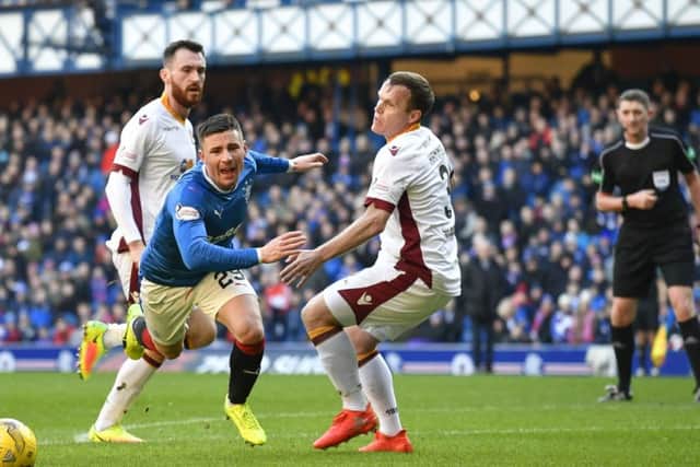 Craig Thomson, right, looks on as Michael O'Halloran goes to ground. Picture: SNS
